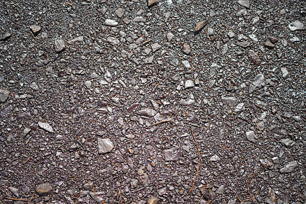 Dirt, terrain or gravel stone road surface pattern in outdoor environmental. Background and textured photo.