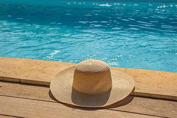 Hat placed by a swimming pool in summer