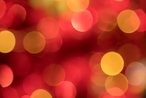 Soft red bokeh abstract background with glowing light circles and warm festive blur