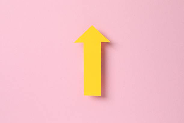 istock Paper arrow on color background, top view 2253454269