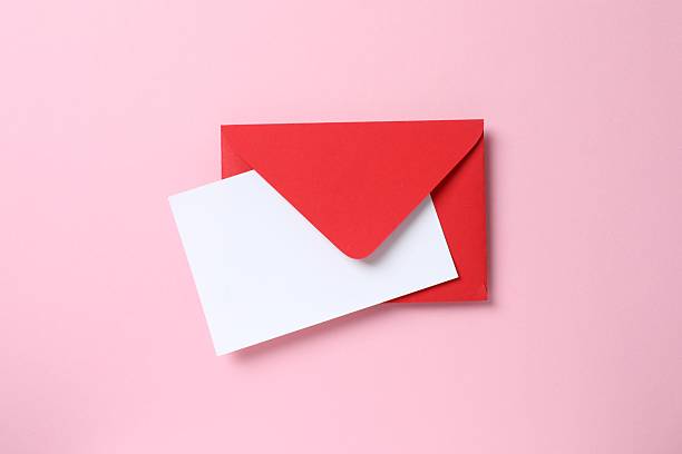 istock Top view photo with paper card and envelope on pink background with empty space 2253454290