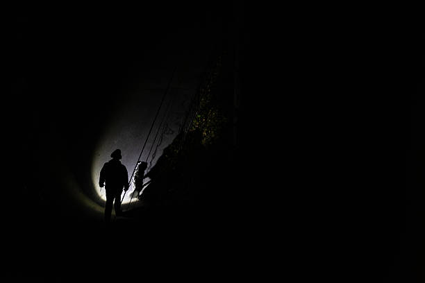Lonely man silhouette against backdrop of foggy night city