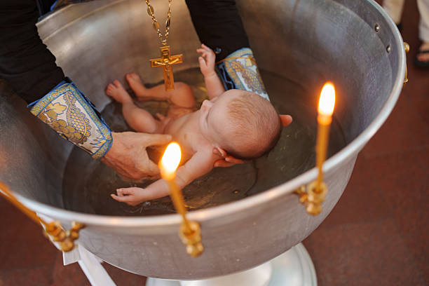 istock Baptism ceremony taking place in a church setting 2253456787