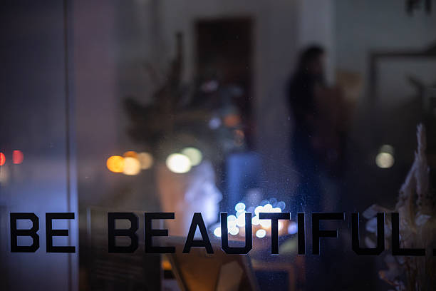 Kyiv, Ukraine  Dec 21, 2022: Tarasivska Street glass window with text Be Beautiful illuminated from inside during total blackout. Energy crisis, urban survival, beauty business resilience, winter.