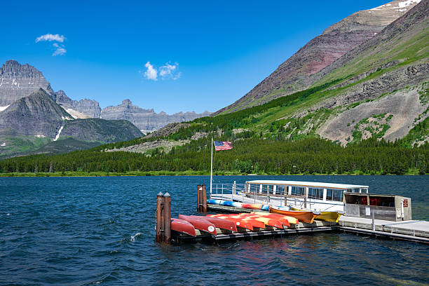 istock Boat on Alpine Lake Beneath Dramatic Mountain Peaks 2253458178