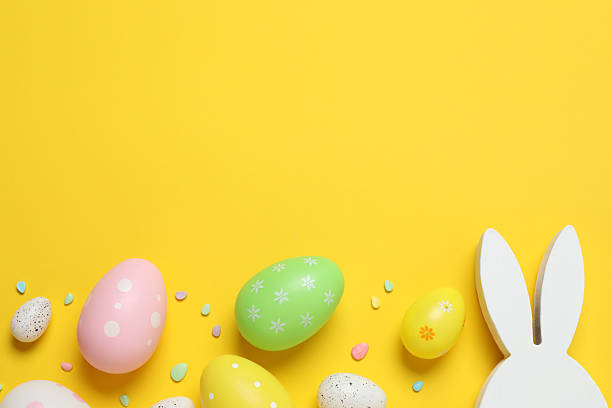 istock Happy Easter. Colorful eggs, bunny ears on a pastel color background, space for text or advertising 2253459133