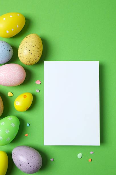 istock Happy Easter. Colorful eggs and white paper card on color background, space for text or advertising 2253459160