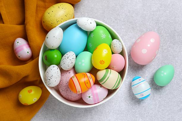 istock Happy Easter. Colorful eggs in a bowl on grey background, space for text or advertising 2253459227
