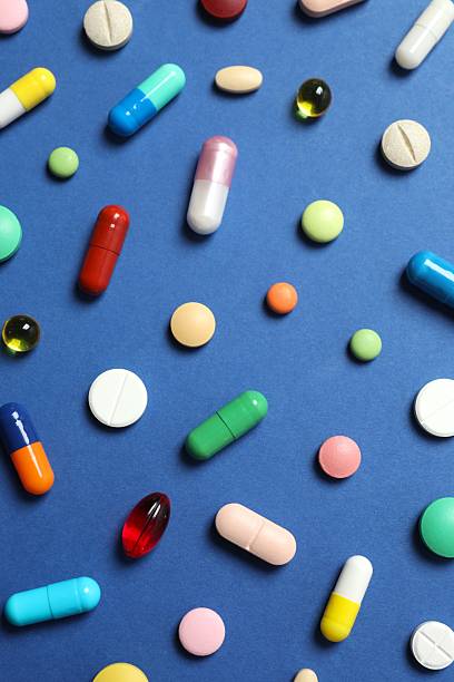 istock Various medical pills on blue background 2253459733