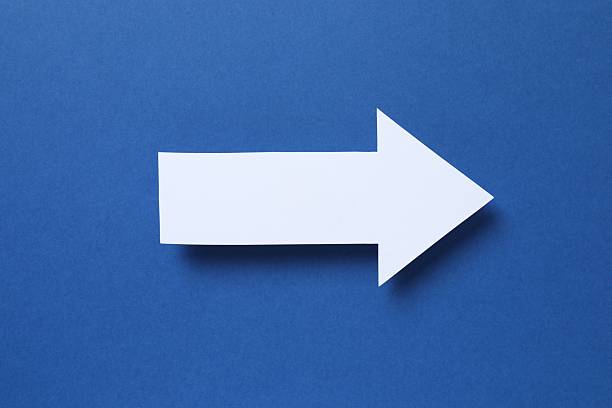 istock Paper arrow on color background, top view 2253459779