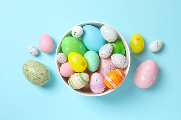 istock Happy Easter. Colorful eggs in a bowl on color background, space for text or advertising 2253459853