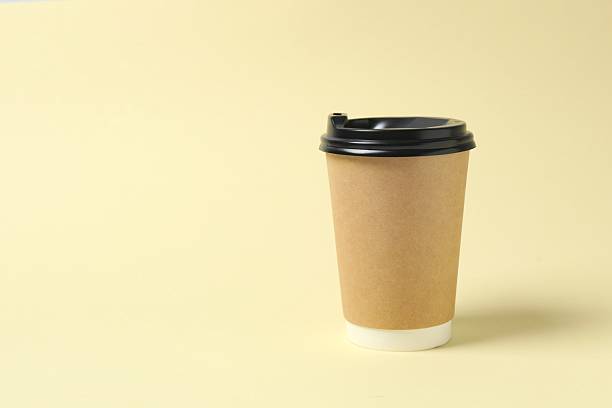 istock Paper cup with plastic lid on light background. Coffee to go 2253459885