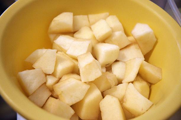 istock Chopped apple in yellow bowl close-up 2253459991
