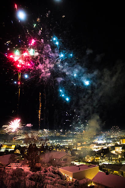 istock Bright firework explosions over Trondheim city lights in portrait view. 2253460702