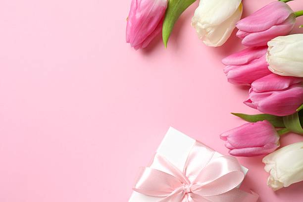 istock Beautiful fresh tulips with gift box on pink background 2253462462