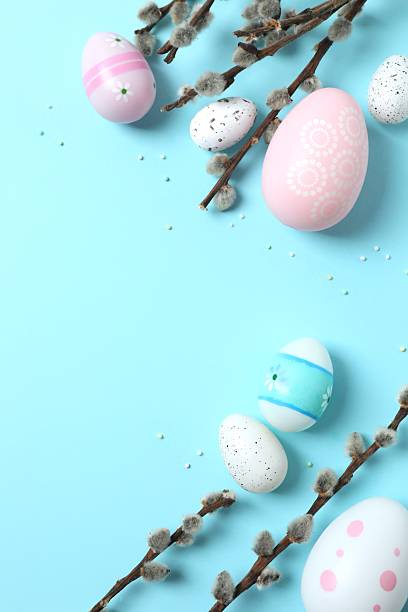 istock Colorful eggs, pussy willow branches, sweet sprinkles on a pastel beige background, space for text or advertising 2253462828
