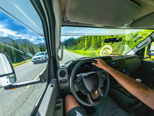 Man driving a car on the scenic icefields parkway, a major tourist route between lake louise and jasper in the canadian rockies, alberta, canada