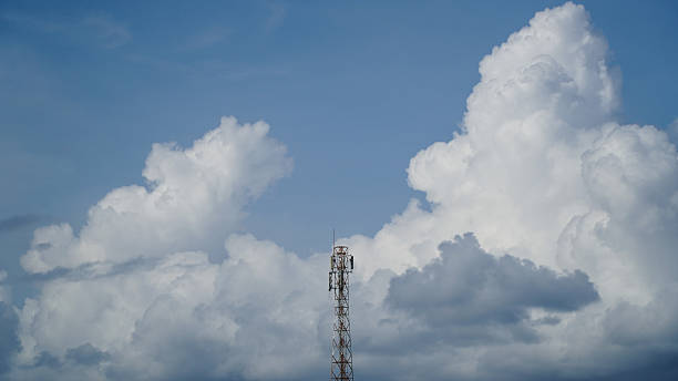 istock Telecommunication Tower Against Blue Sky and Puffy White Cumulus Clouds 2253463927