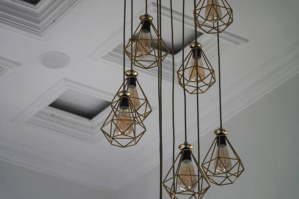 istock Modern Geometric Pendant Lights Hanging from a White Coffered Ceiling 2253463932