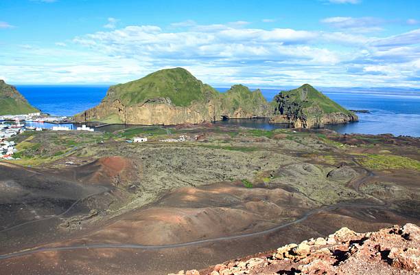 istock Wide view of Heimaey harbor and lava fields from Eldfell, Iceland. 2253464087
