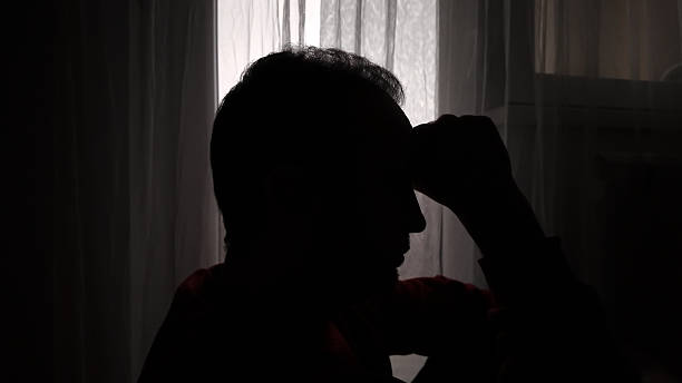 istock Man with headache, depression, sadness and loneliness at home 2253467714