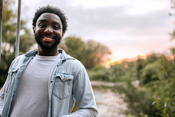 istock Young casually clothed man posing for camera outdoors in nature 2253468235
