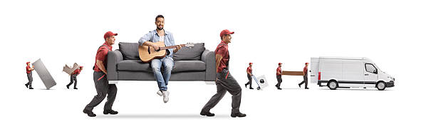 Movers with van carrying a sofa with a man sitting and playing an acoustic guitar isolated on white background