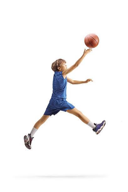 Boy jumping and enjoying a basketball game isolated on white background