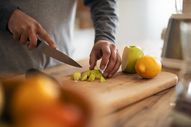 istock Home Kitchen Preparation With Knife Chopping Apple On Cutting Board For Fresh Fruit 2253469265