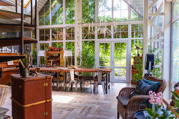 istock Dining area with large windows and plants in the background 2253469352