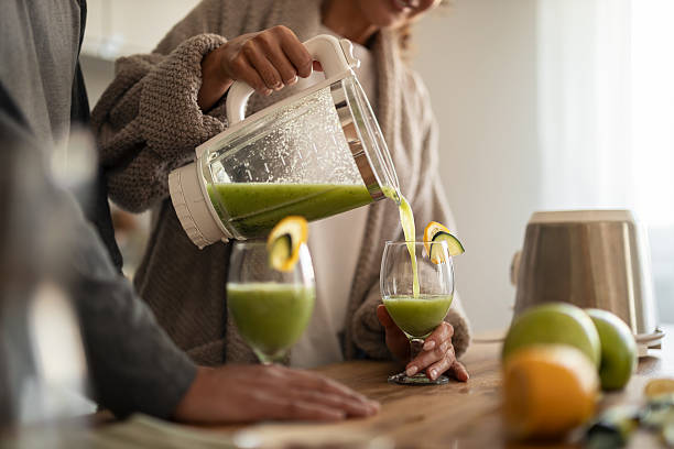 istock Couple Making Fresh Green Smoothies At Home In A Modern Kitchen Setting 2253470069