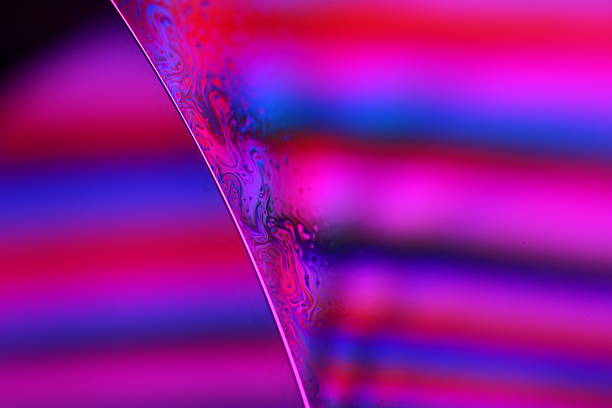 Abstraction of a closeup of a backlit pair of glass vases in a shop window.