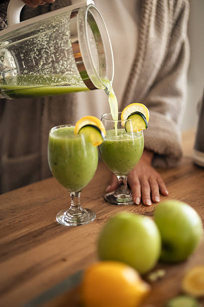 istock Green Smoothie Pour: Fresh Apple, Lemon, and Cucumber Drinks For Cozy Home Gathering 2253471421