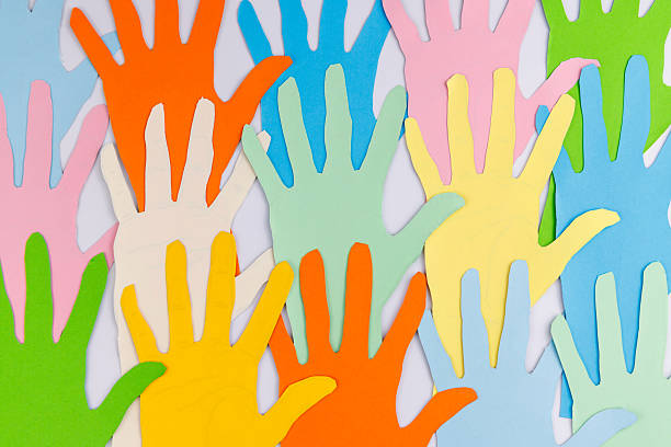 istock Dynamic wave of colorful paper hands on white background for Human Rights Day representing the movement for change and social activism. 2253471957