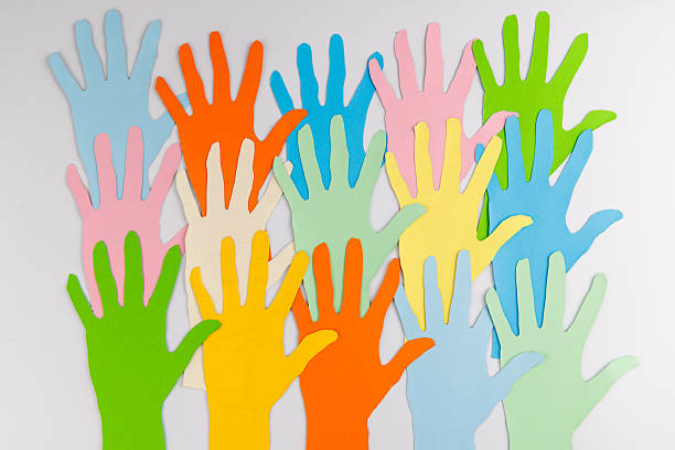 Small and large paper hand cutouts on a white background illustrating that human rights are universal for every generation in our global society.