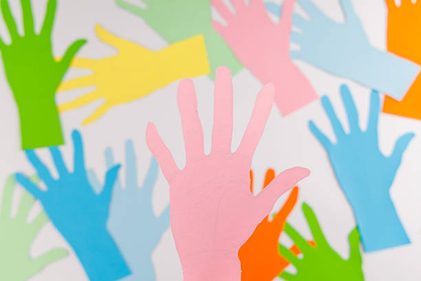 istock Paper hands forming a path on a white background for Human Rights Day representing the journey toward global justice and social equity. 2253472063