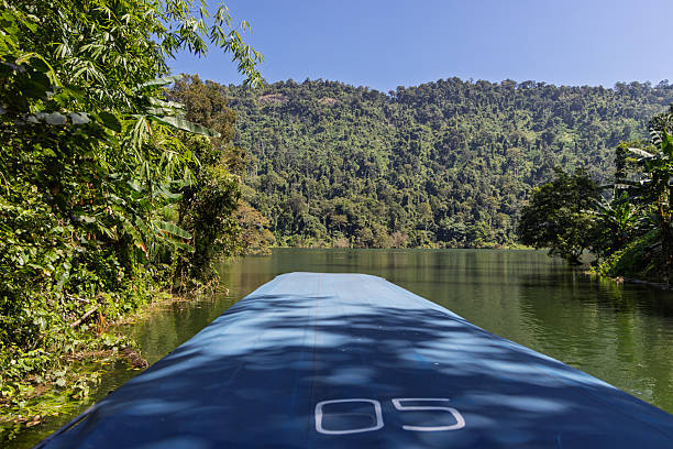 istock boat on calm lake with dense jungle backdrop in khao yai 2253472472