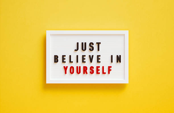 Just believe in yourself written lightbox on yellow background. Horizontal composition.
