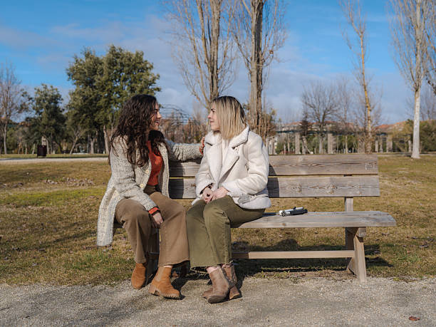 istock Friend supporting visually impaired woman on park bench 2253473119