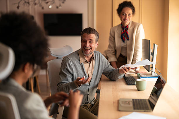 istock Friendly Business Meeting In Modern Office With Team Members Discussing Documents And Ideas 2253474837