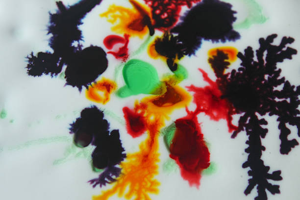 Abstract colorful watercolor art on white surface with spreading texture