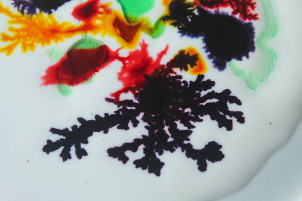 Abstract colorful watercolor art on white surface with spreading texture