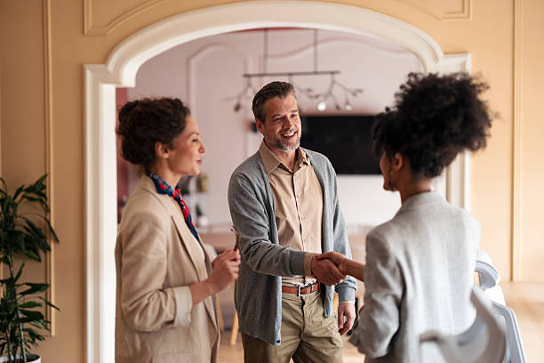 istock Friendly Business Meeting With Handshake Between Colleagues In Modern Office Setting 2253474953