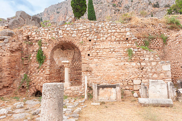 The archeological site Delphi in Greece is located on multiple terraces with supporting stone walls along the slope of Mount Parnassus. The ancient Greeks considered Delphi to be the centre of the world and marked the place with a stone monument, a navel (omphalos). Delphi was the home of oracles that were consulted before important decisions were made. The sacred precinct is situated at the south-western slope of Mount Parnassus and is recognised by UNESCO as a World Heritage Site. The image was captured with a full frame DSLR camera and a sharp lens at low ISO and is part of a series of photographs of Delphi.