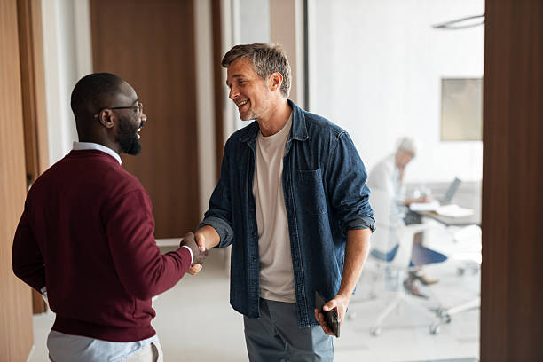 istock Friendly Handshake Between Colleagues In A Modern Office Setting For Business Meeting 2253476222