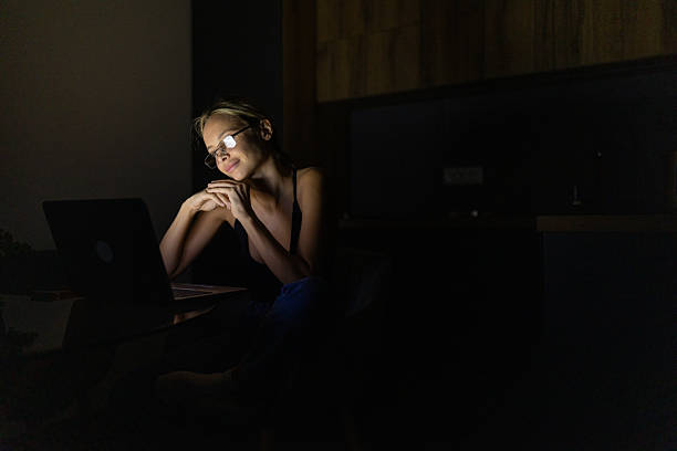 istock Beautiful woman working from home at night 2253477875