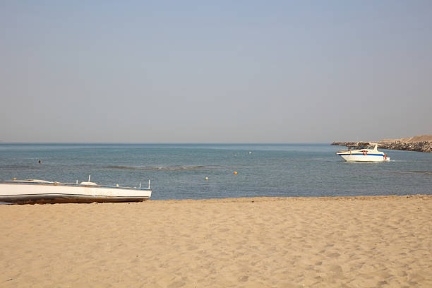 A woman is walking on beach after swimming.Sanur beach - Bali Island - Indonesia.