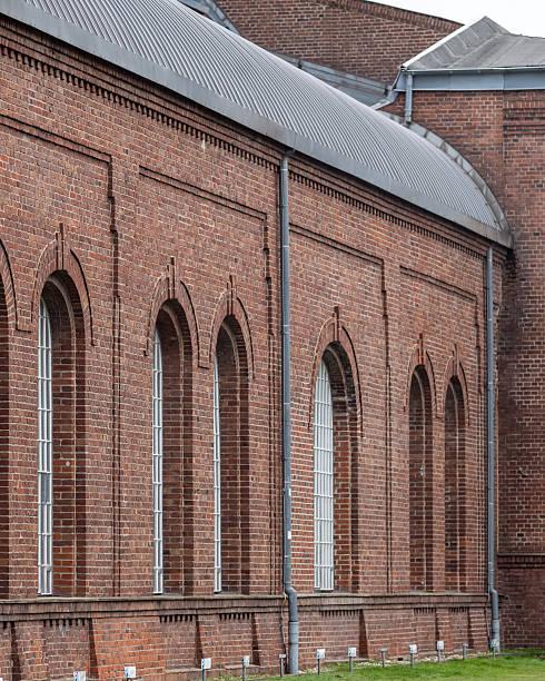 istock Brick building with arched windows and green lawn in a quiet area 2253478700