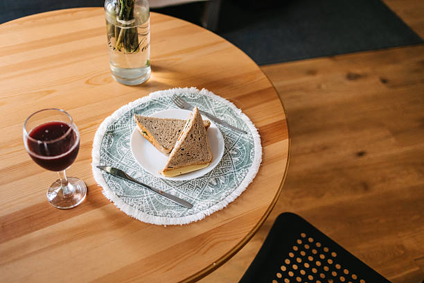 istock Simple breakfast on wooden table with sandwich and juice 2253479203