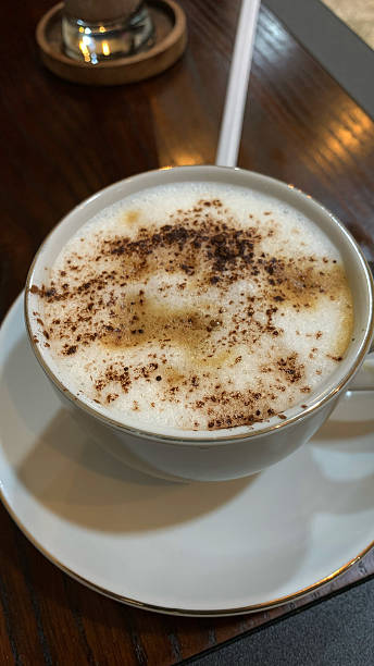istock Frothy Cappuccino with Cocoa Powder on a Wooden Table 2253479412